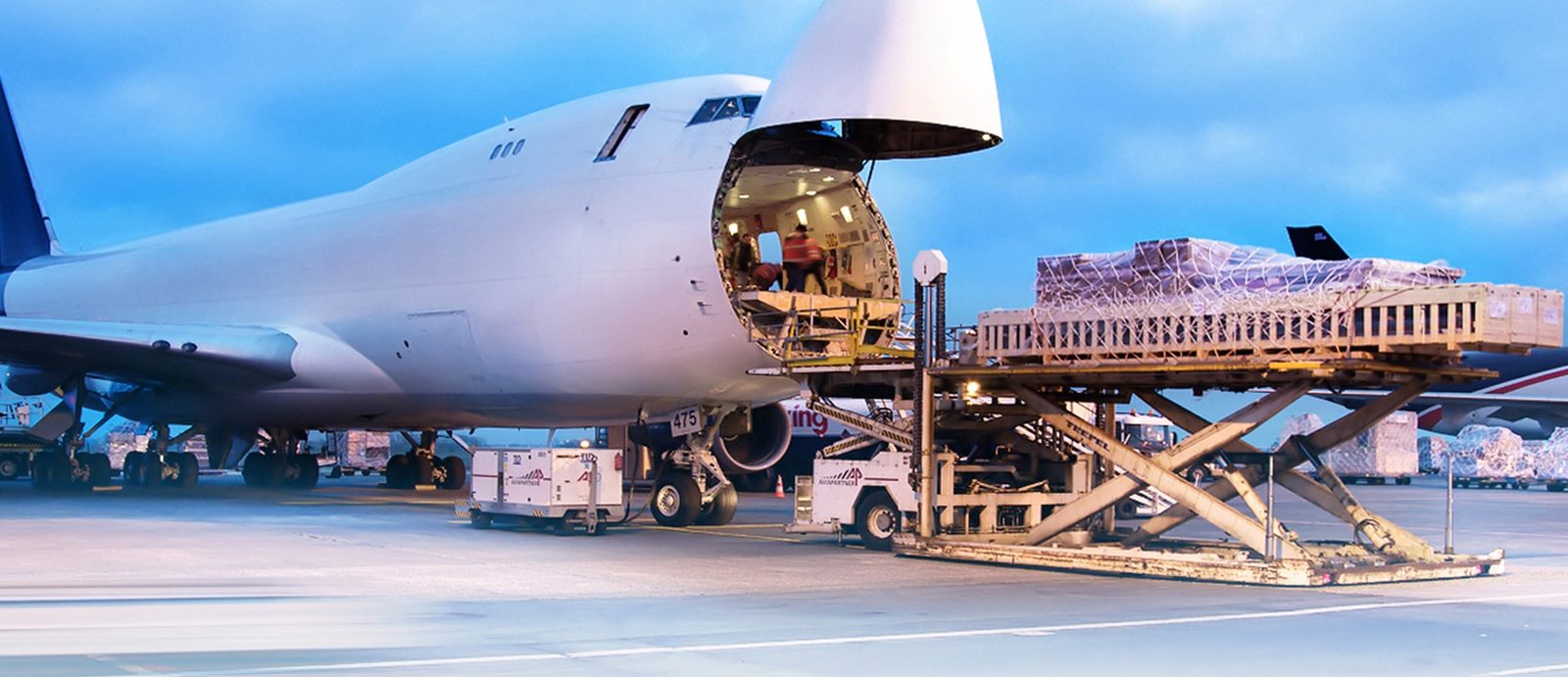 Palletised air cargo being loaded through the nose door of a freighter aircraft