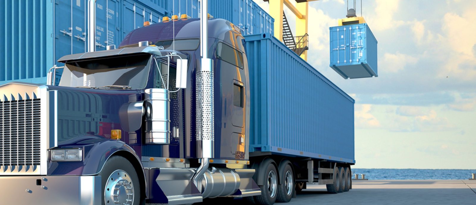 Container truck at a quayside yard while a crane lifts a container overhead